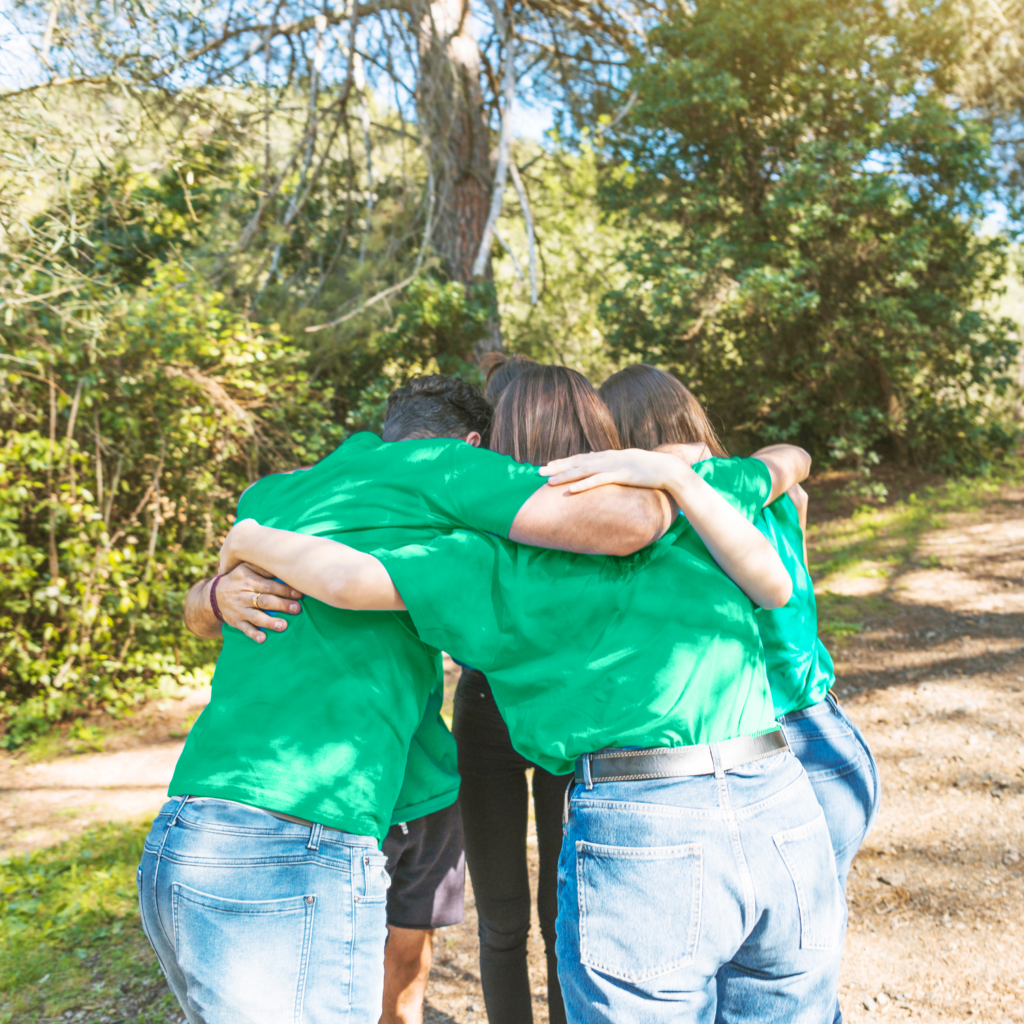people hugging circle forest